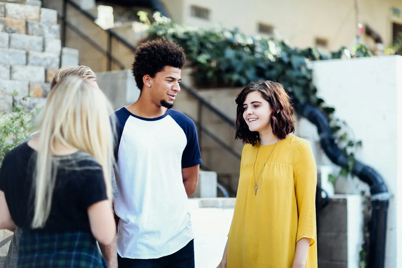 Three students in conversation outside a campus building