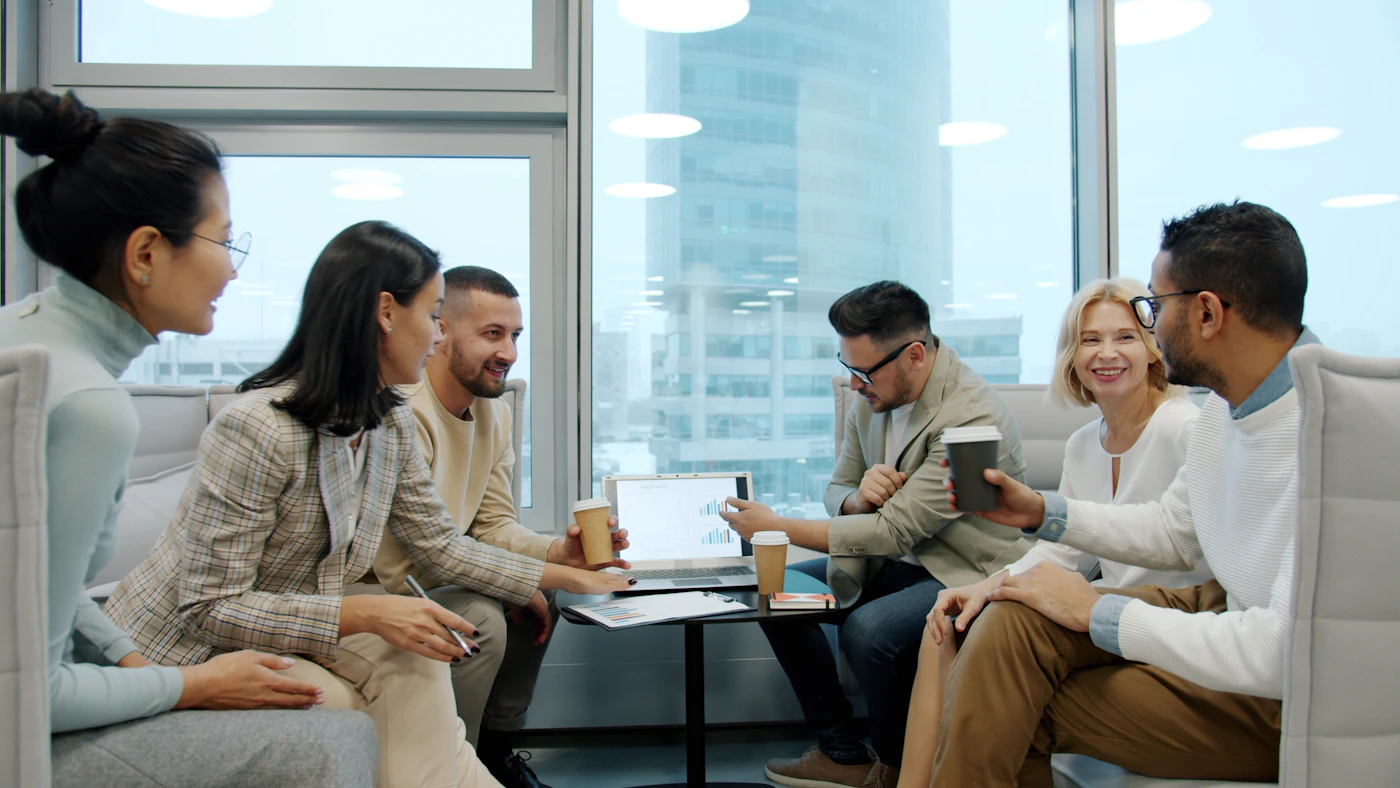 Students and mentors gathered in a modern meeting room for a professional development discussion